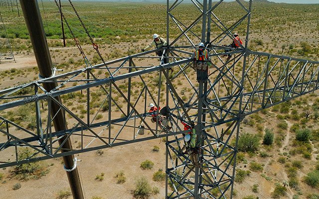 Electricians working on power lines