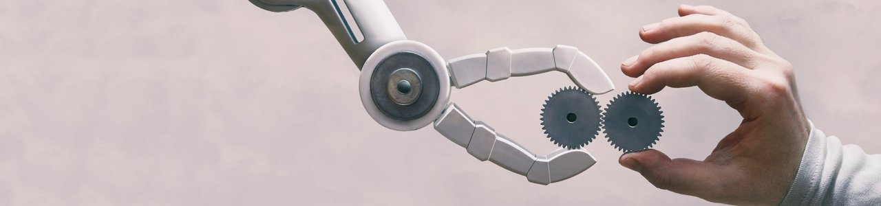 A robot arm and a human hand holding cogs towards each other