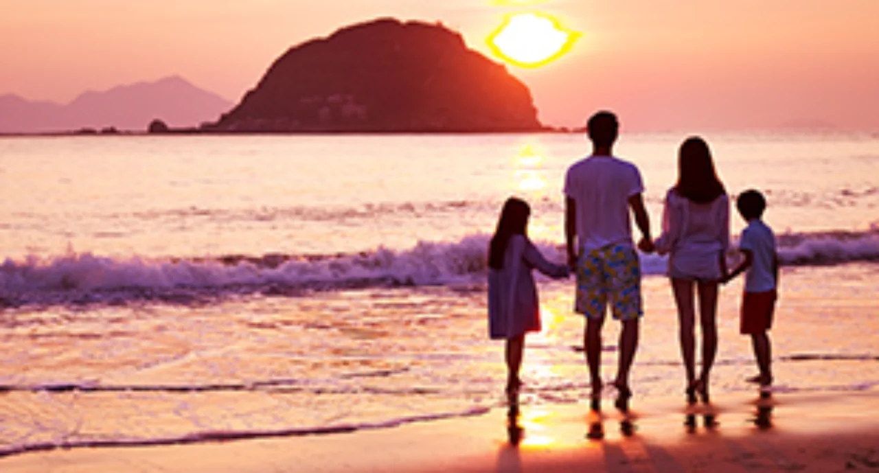 family at the beach on sunset