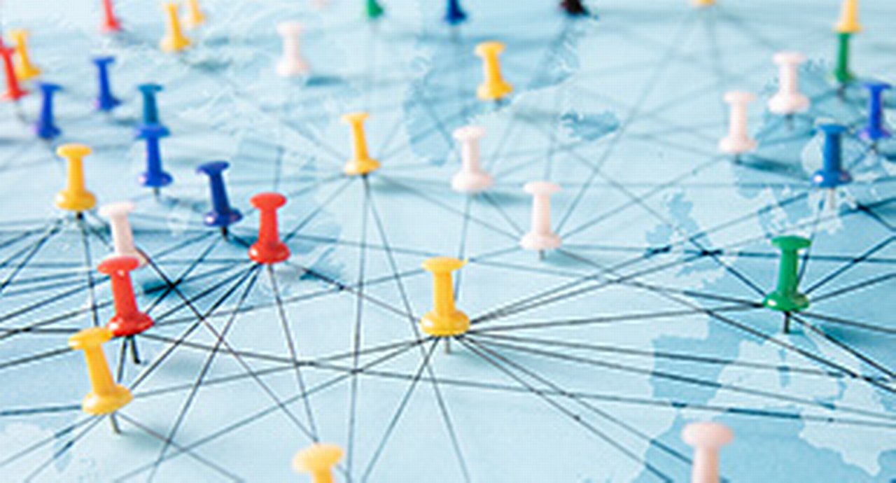 Connection concept with push pins on a world map