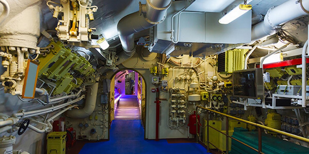 A modern complex ship's engine room indirectly illuminated