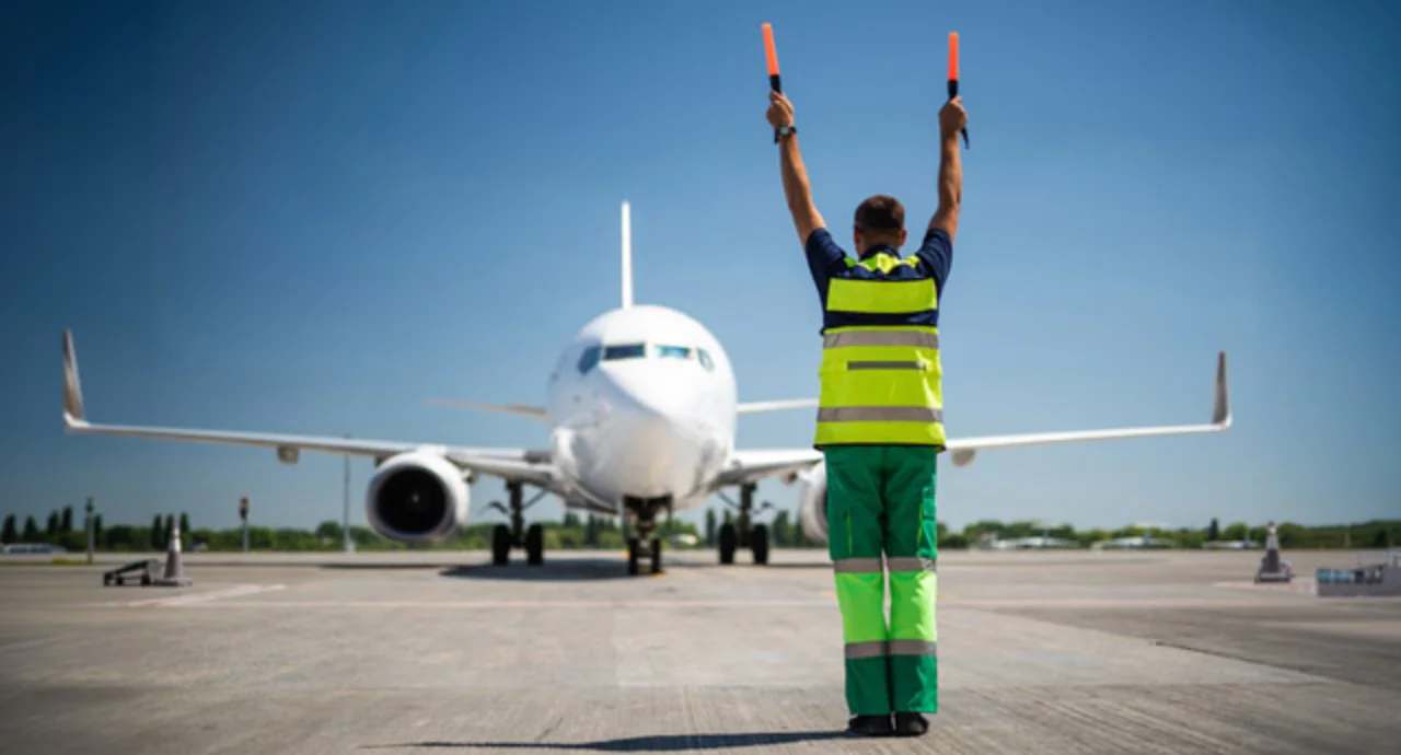 Aviation marshall raising hands and signaling