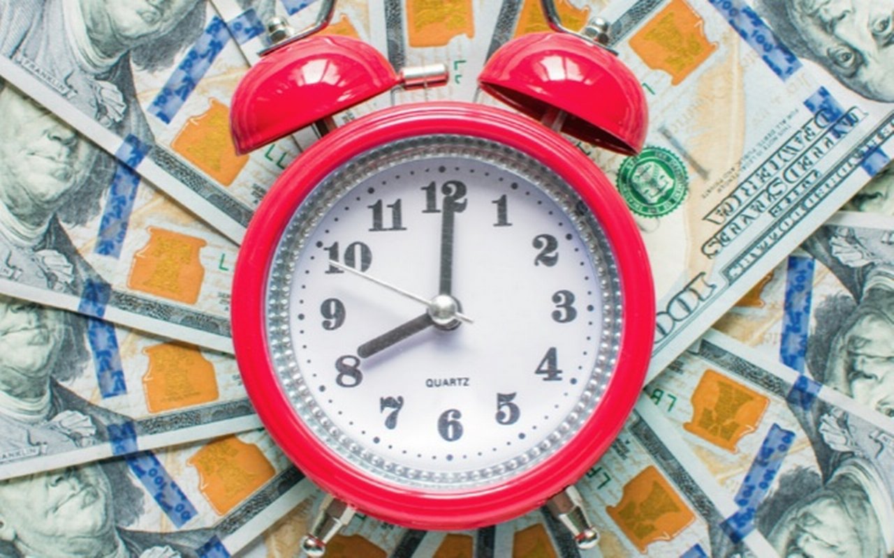 A layer of money with a clock in the middle