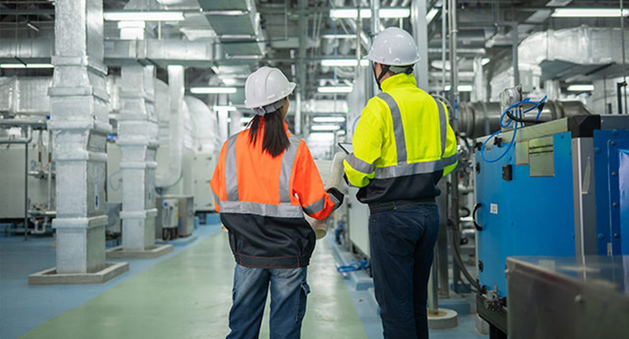 Engineers Or Technicians Working Extensive Metal Piping