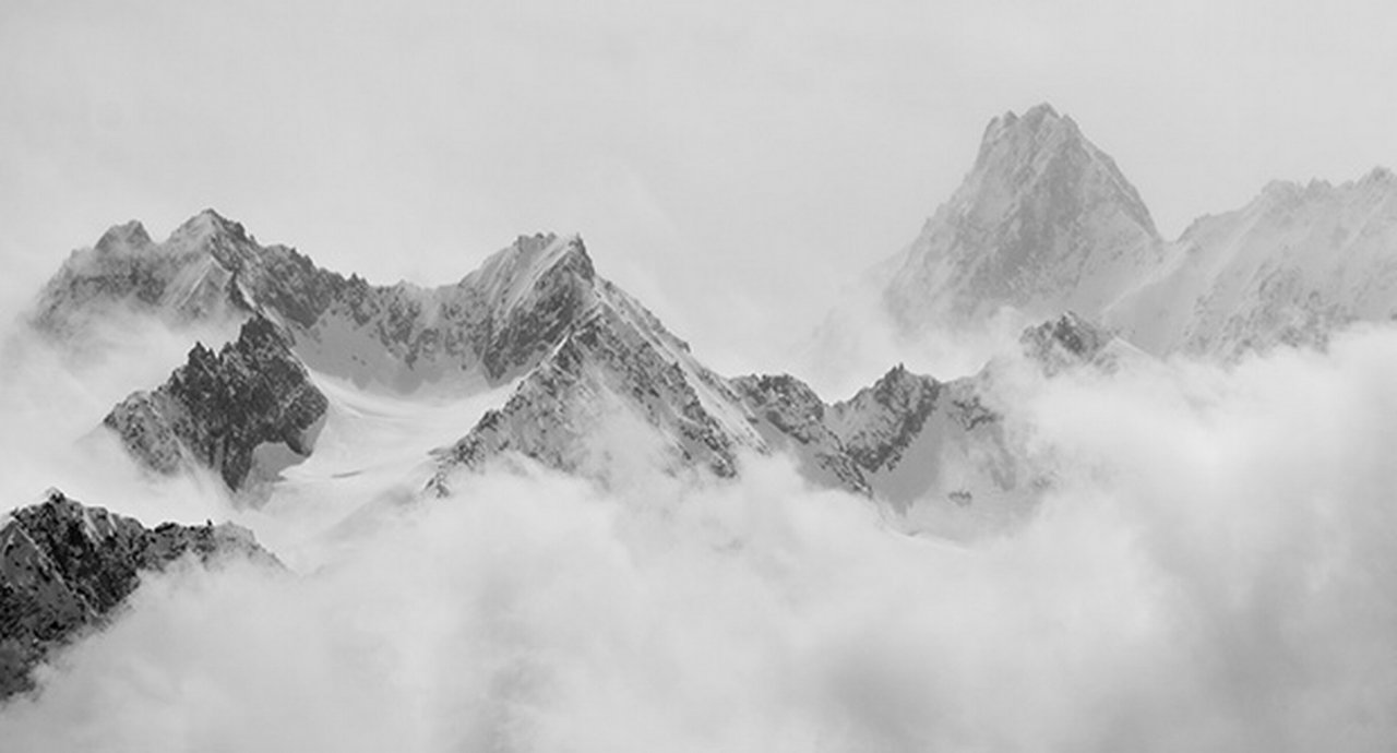 Atmospheric clouds linger around the peaks of the Swiss alps after a spring snow storm.