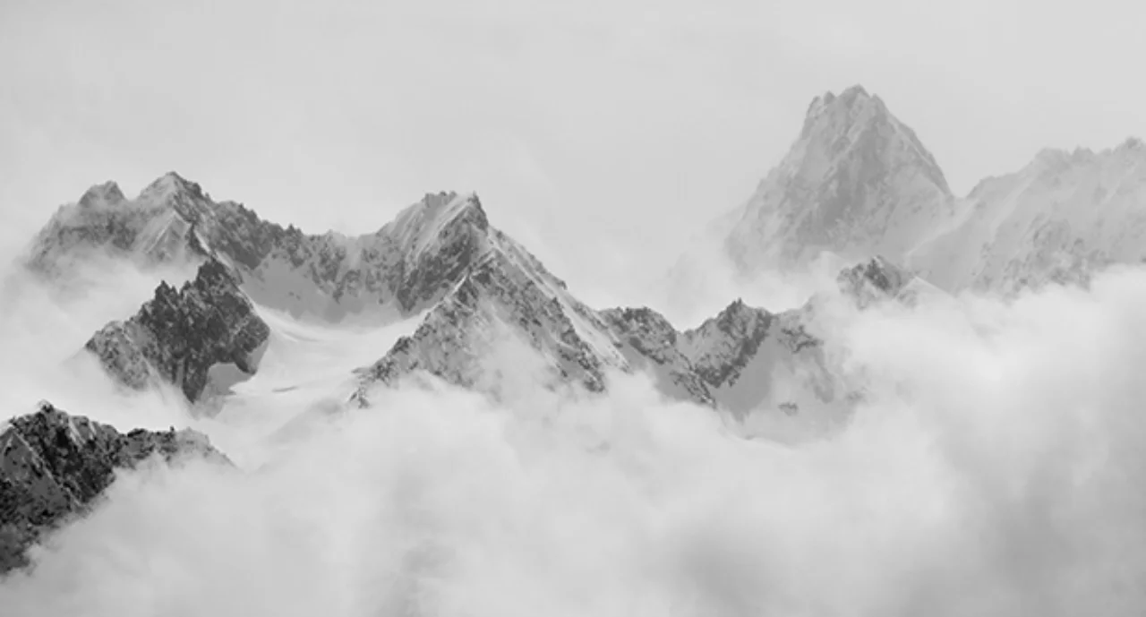 Atmospheric clouds linger around the peaks of the Swiss alps after a spring snow storm.