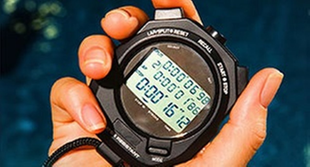 Hand holding digital stopwatch