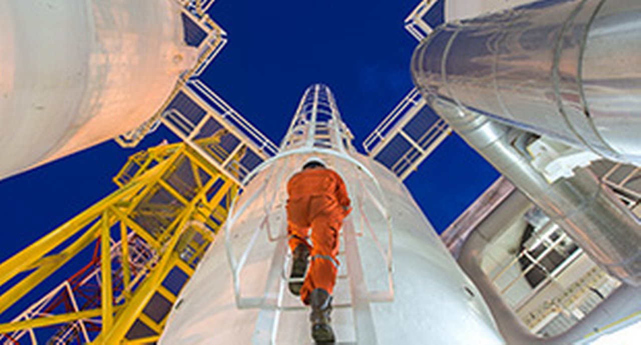 Engineering climb up to oil and gas process plant to observer gas dehydration processing in night shift