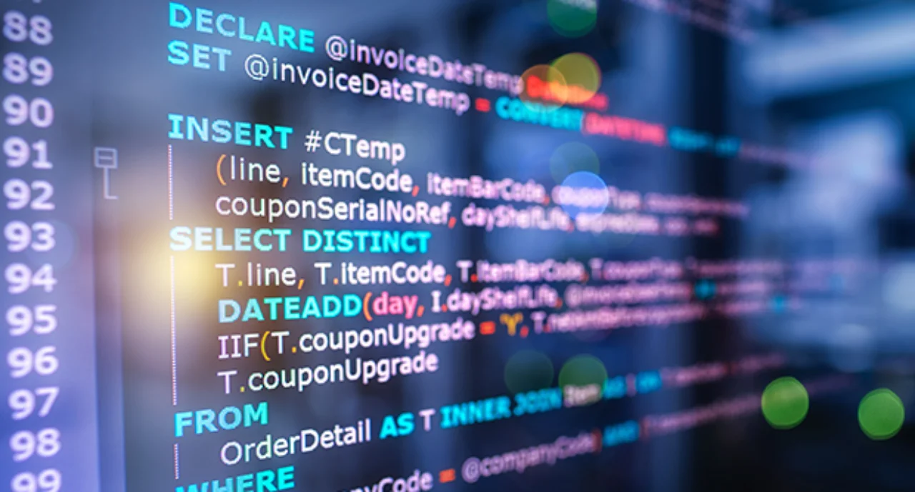 SQL (Structured Query Language) code on computer monitor and server room background. Example of SQL code to query data from a database.
