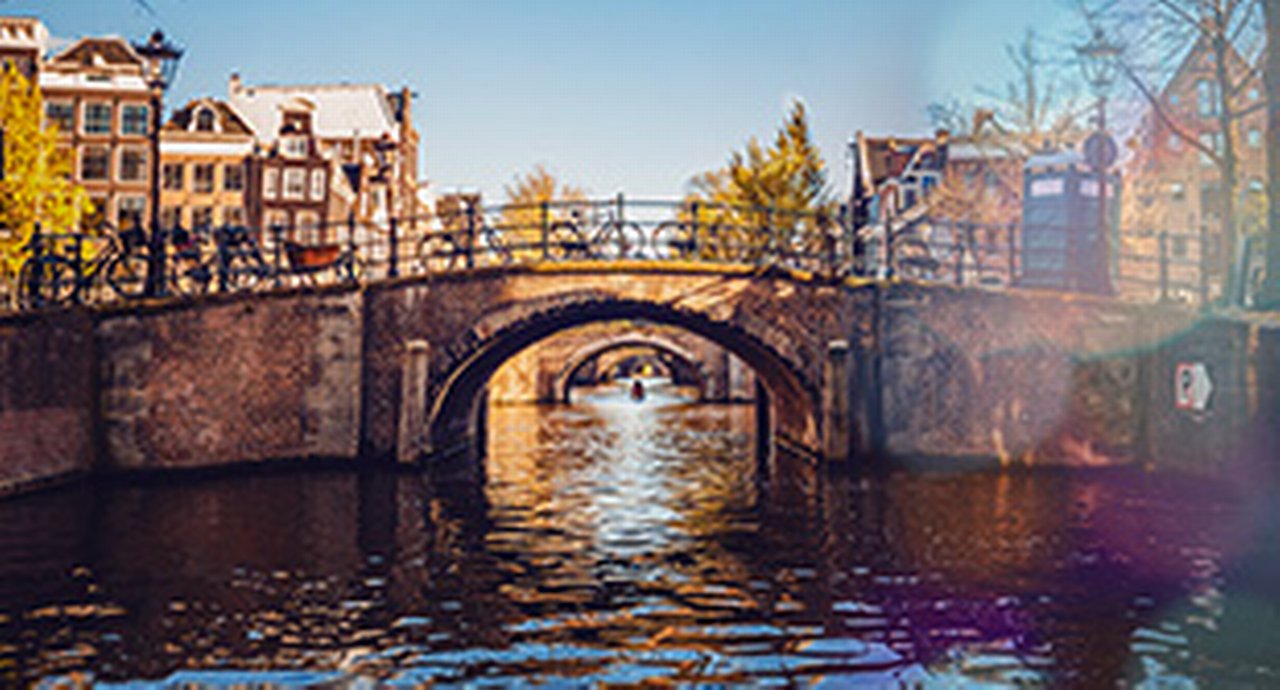 An arch bridge in Amsterdam with many bicycles
