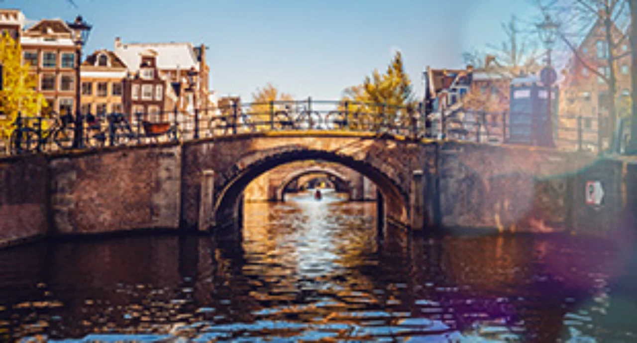 An arch bridge in Amsterdam with many bicycles