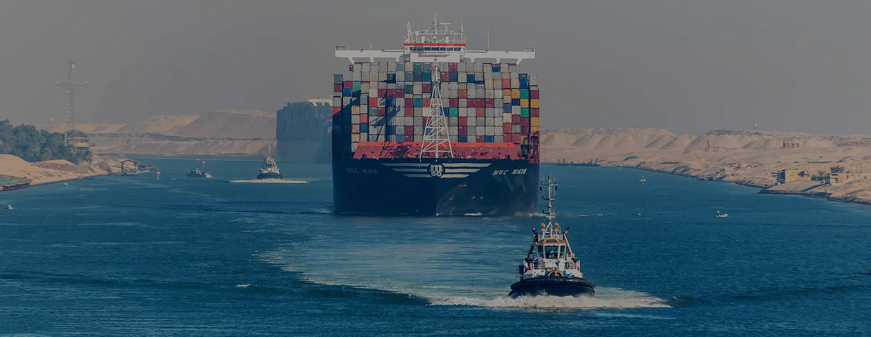 Cargo ship following a tugboat