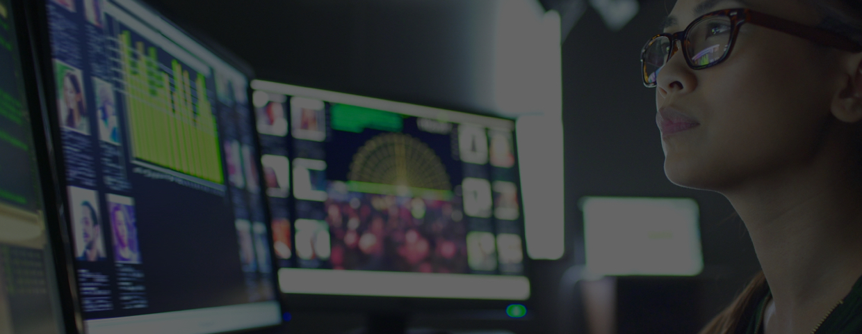 A professional trader monitors her screens