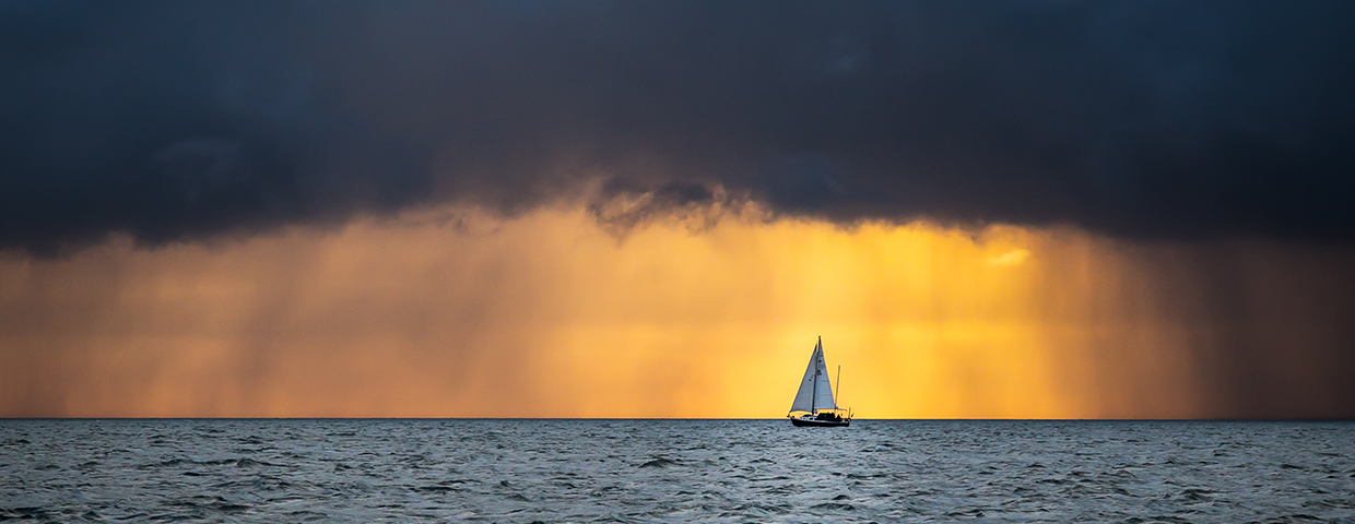Boat Sailing Into The Storm