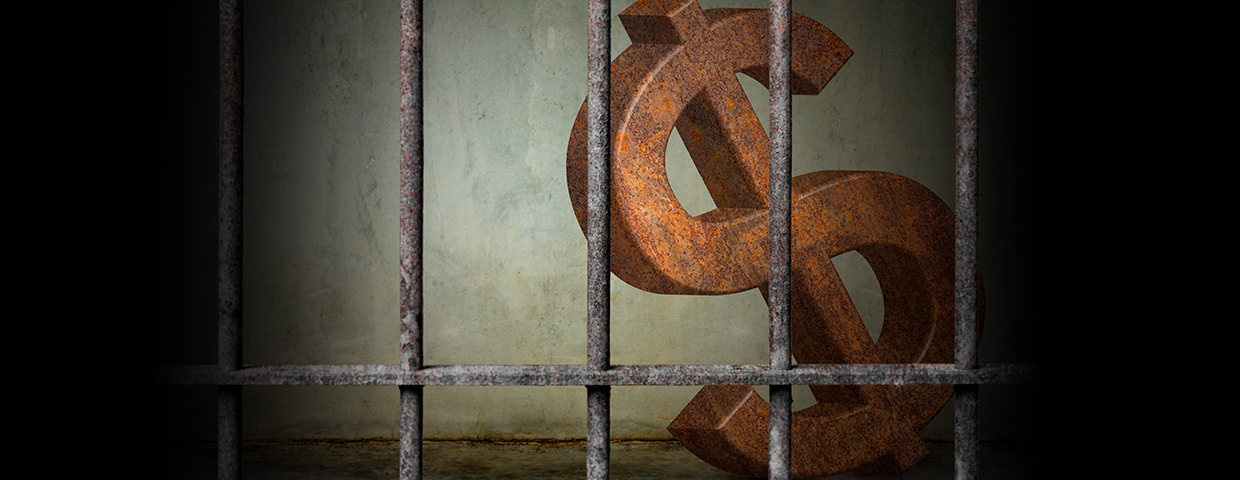 large rusty dollar sign is imprisoned in old prison
