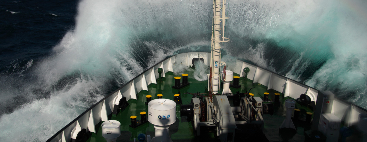 Big wave rolling over the snout of the ship