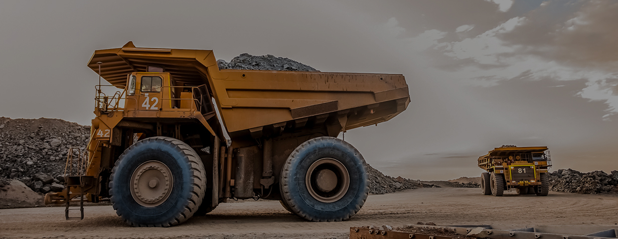 Dump trucks transporting platinum ore for processing