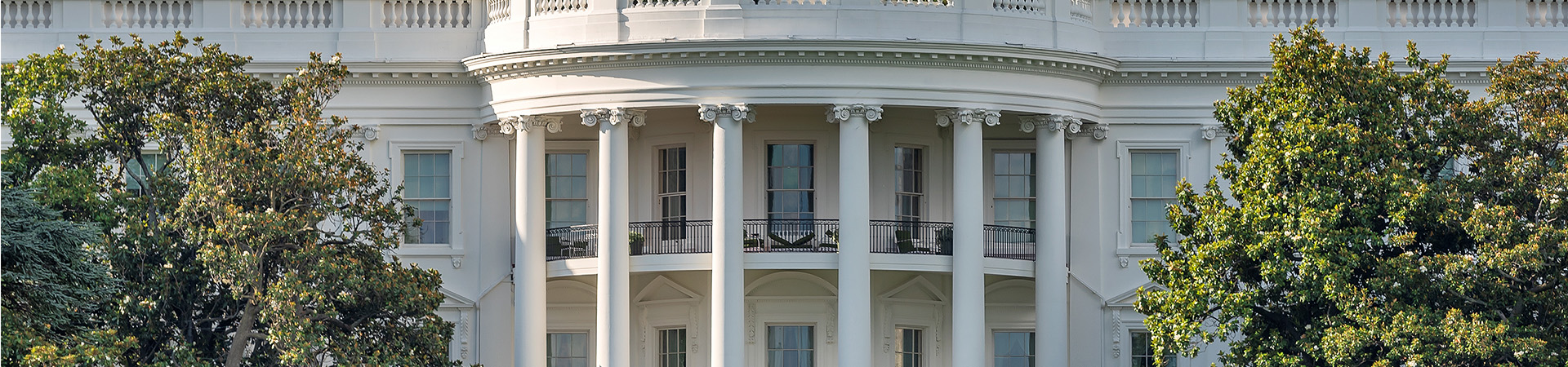 The US  White house with an american flag waving on top