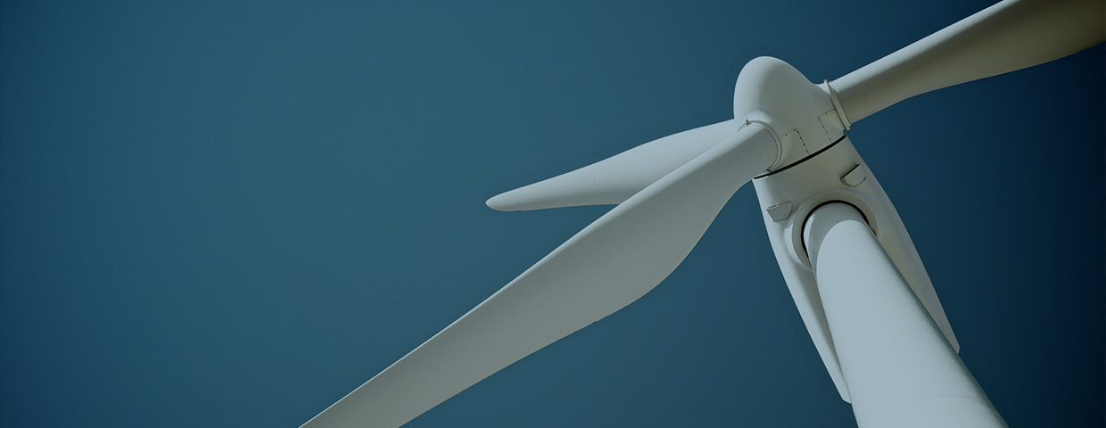 Close-up of a windmill against a deep blue background