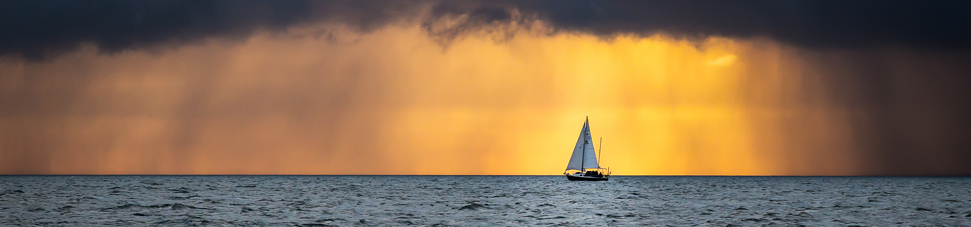 Boat Sailing Into The Storm