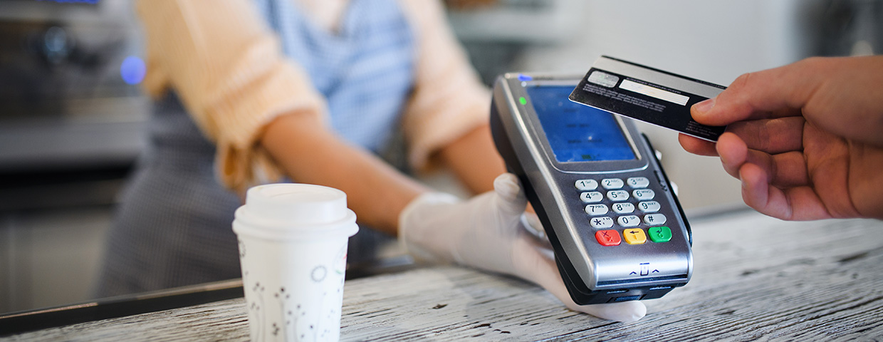 Contactless payment with debit card, coffee shop open after lockdown