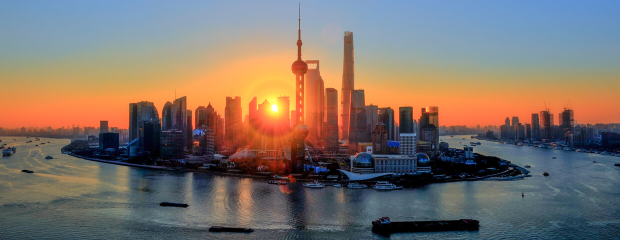 Sunset View of the Bund and Pudong in Shanghai including Oriental Pearl Tower and Shanghai Tower