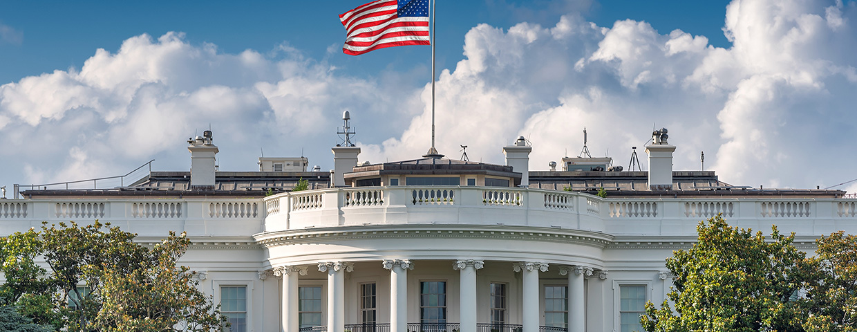 The US  White house with an american flag waving on top