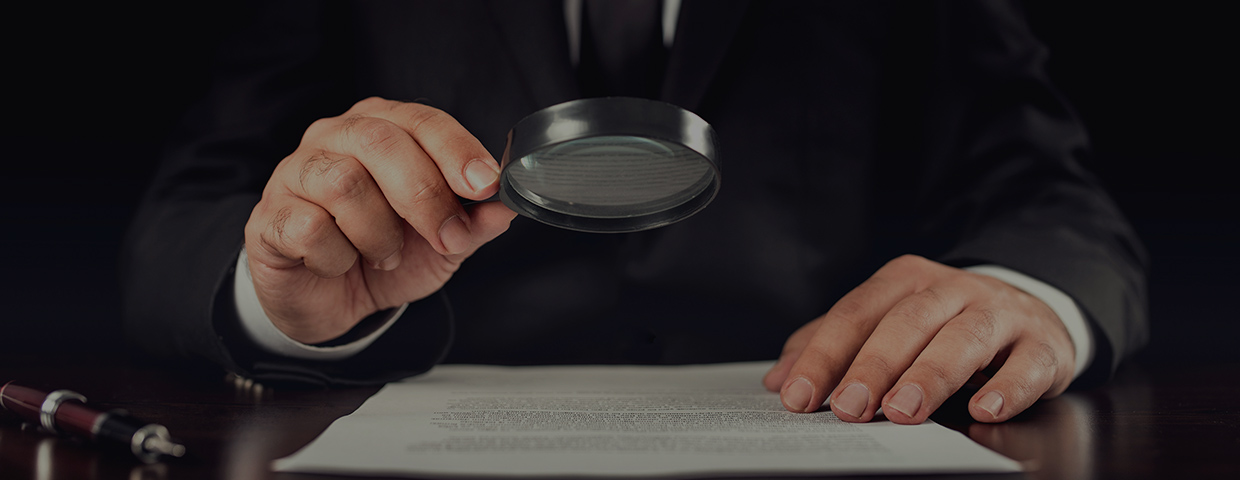 Businessman reading contract details before signing