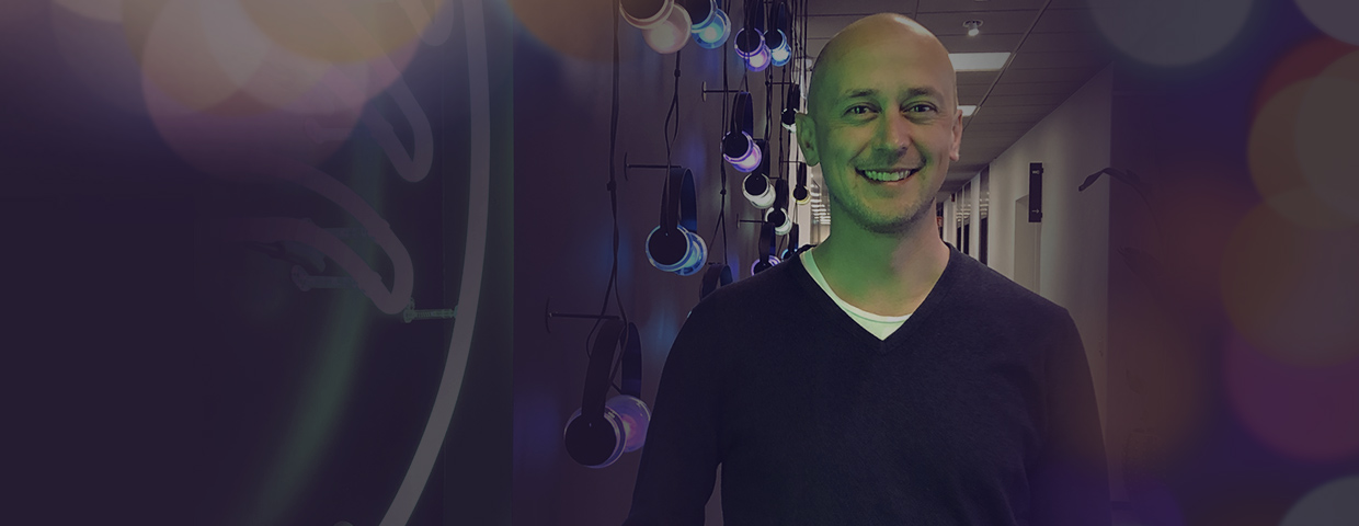 Spotify's treasurer Patrik Hallerström in front of a wall on which illuminated headphones hang