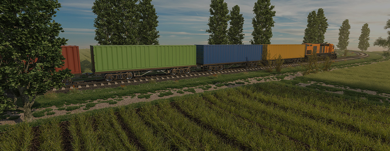 Train boxcars on a green field with trees