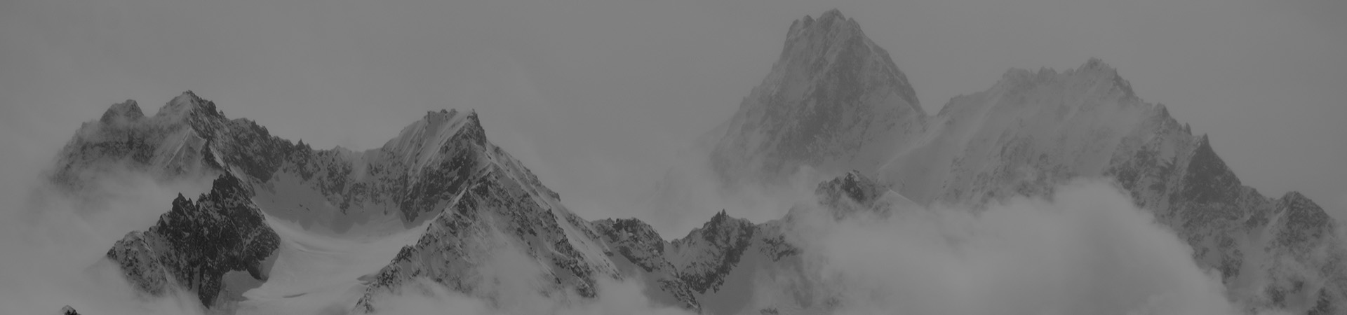 Atmospheric clouds linger around the peaks of the Swiss alps after a spring snow storm.