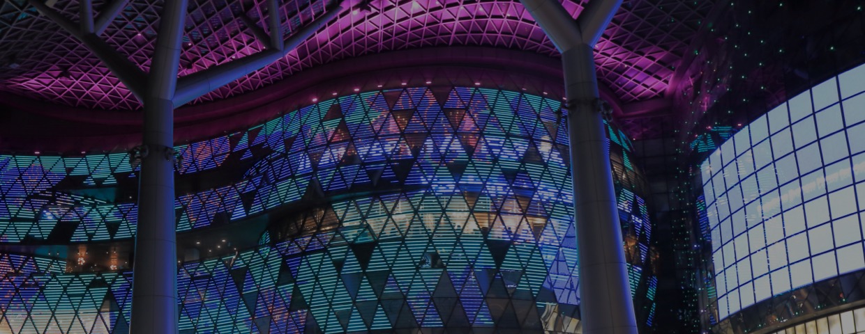 Tourists and local people visit ION Orchard department store by night in Orchard Road shopping district Singapore