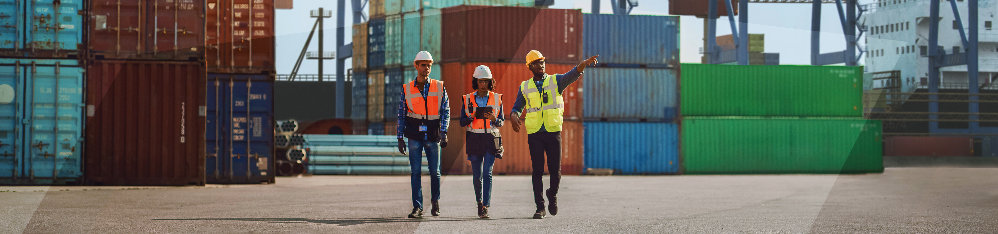 Three dock workers amoung containers