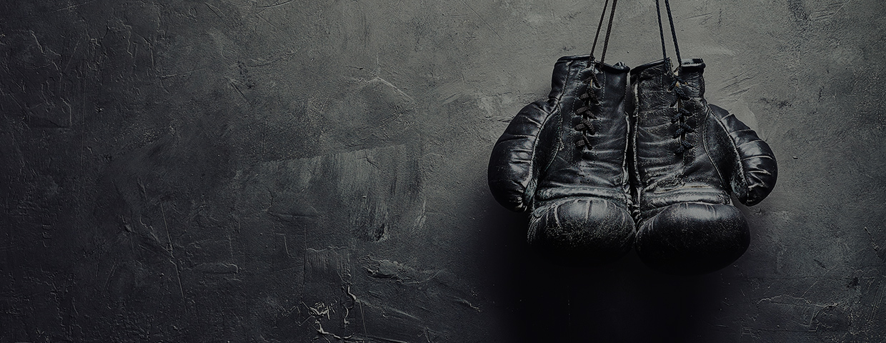 Old Boxing Gloves Nailed To The Textured Wall