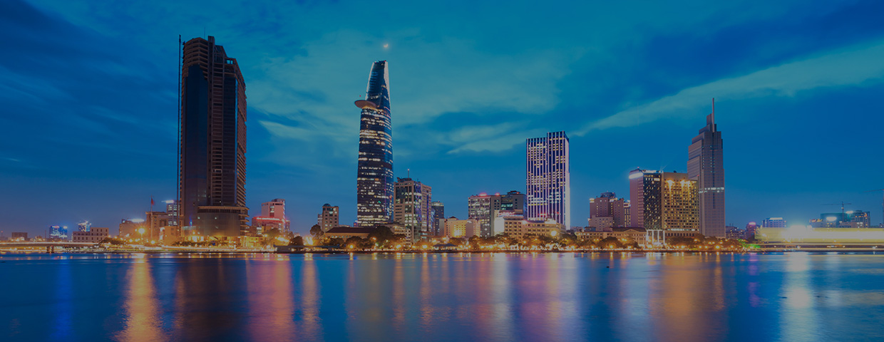 Downtown Saigon skyline in twilight with the sea in the foreground