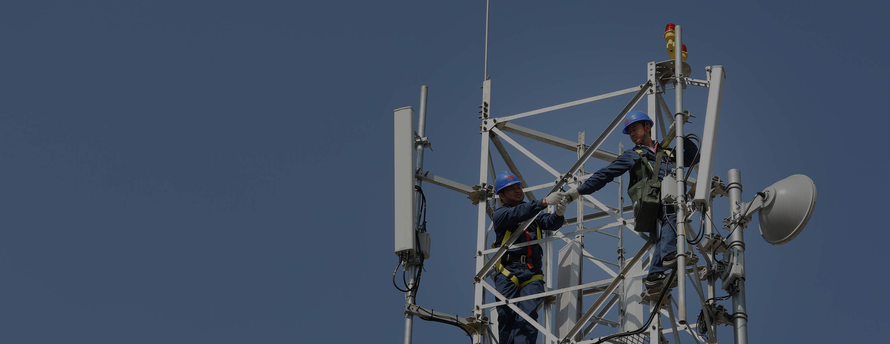 Aerial workers on an antenna under the burning sun