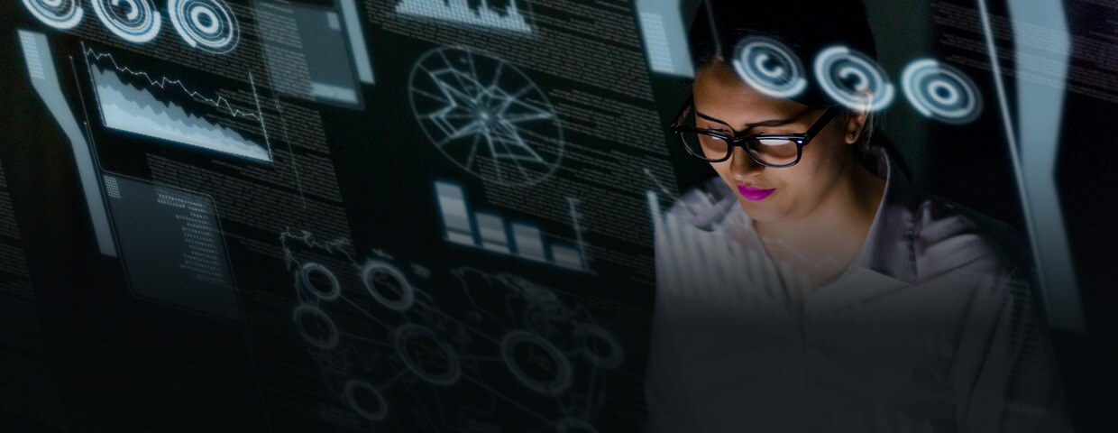 womans head wearing glasses in front of computer graphics and texts