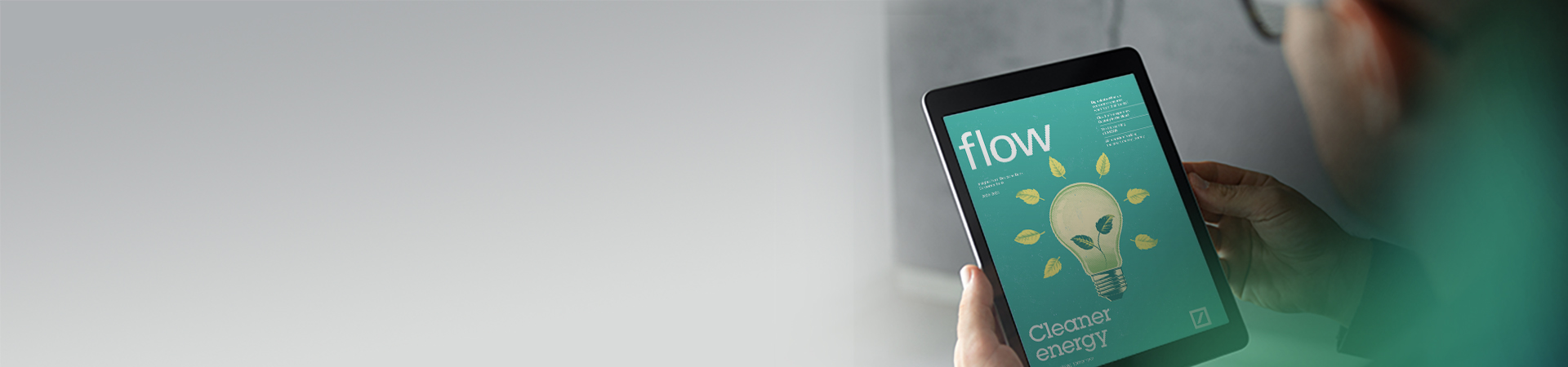 Young professional reading flow magazine 2023-2024 on a tablet