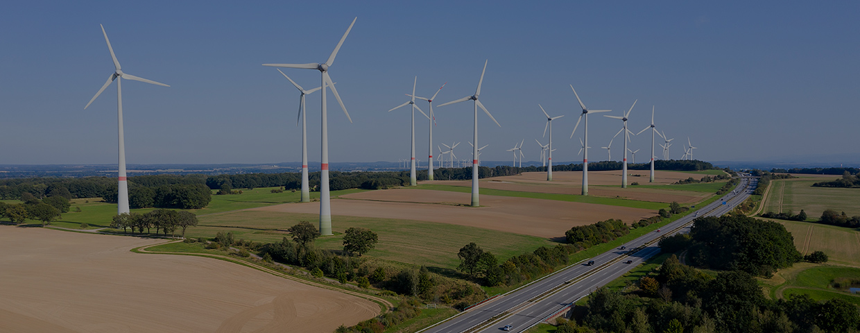 Renewable energy plant - wind turbine farm near the highway, aerial view