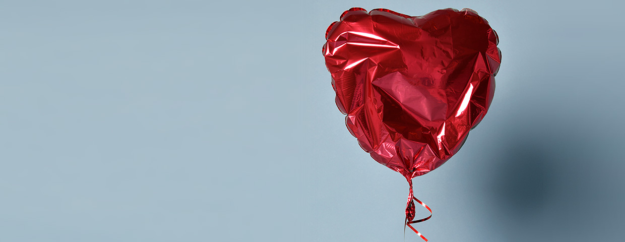 Deflated red heart balloon