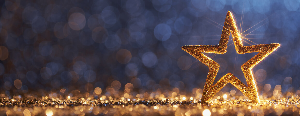 Sparkling Golden Christmas Star - Ornament Decoration Defocused Bokeh Background