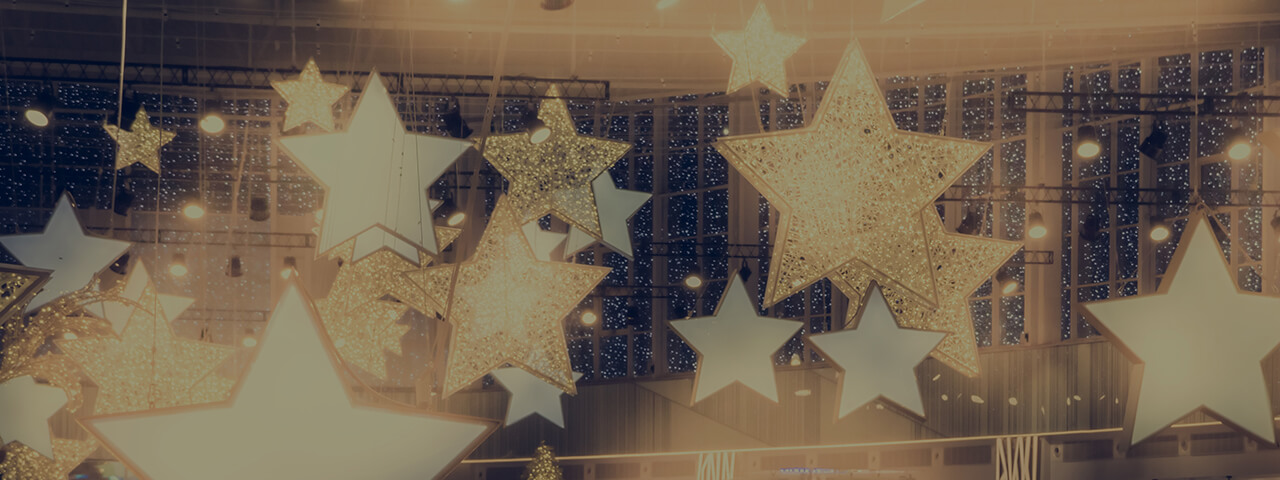 Golden Stars warmly illuminated hanging from the ceiling