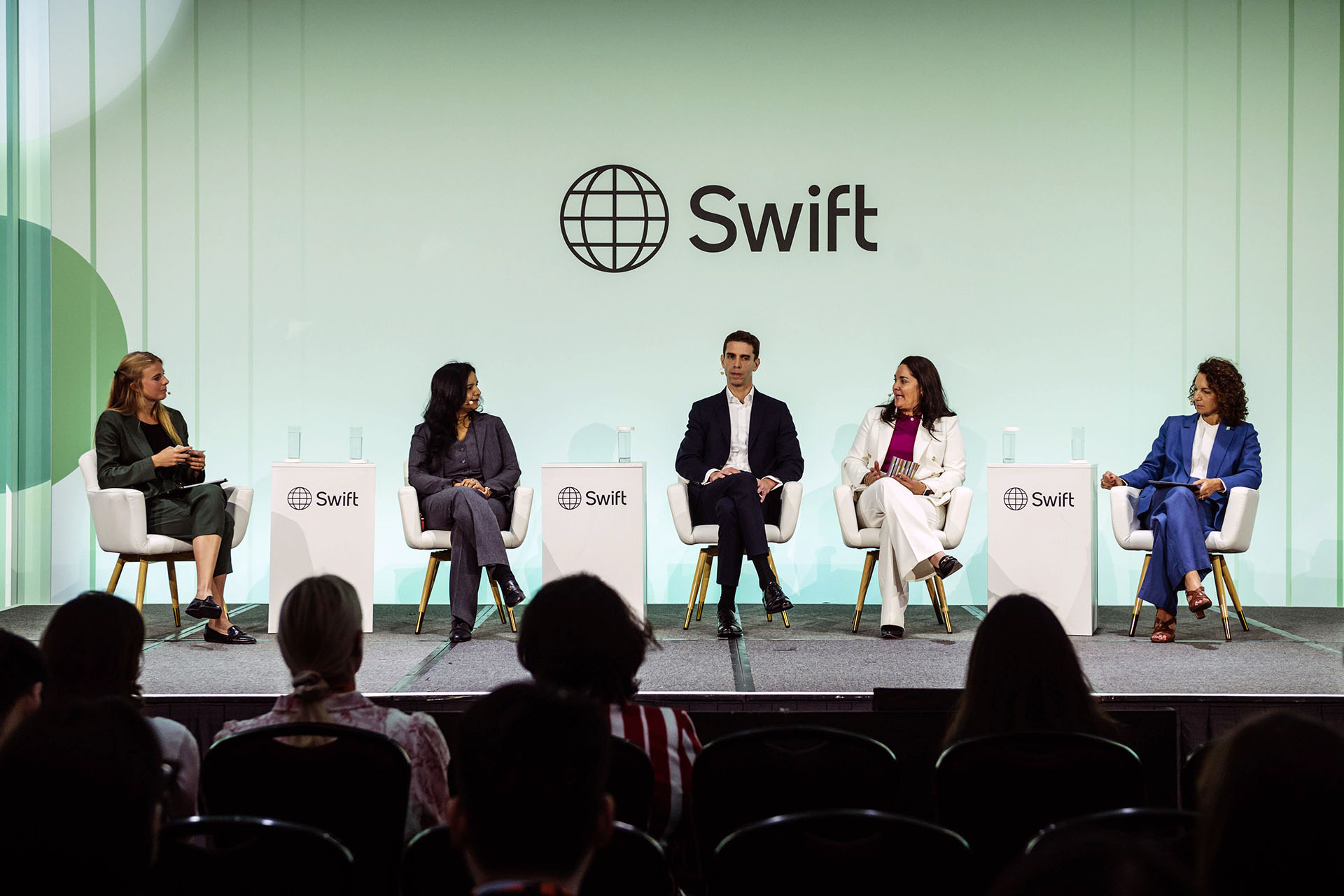 Five panelists participate in a discussion on stage at the Swift conference
